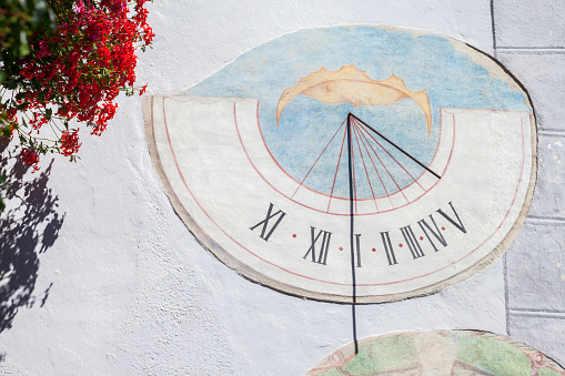 Laion, Italy - September 02, 2020: A recently restored sundial painted outside a private house in the town.