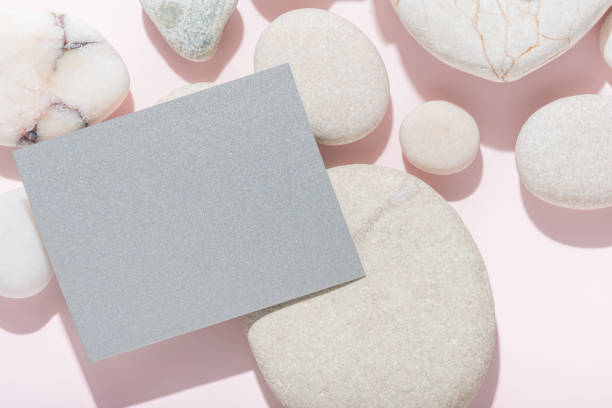istock white stones with shadow on abstract pink background, hard sun lights, spa background concept banner for cosmetic body care product, empty blank 1774729617