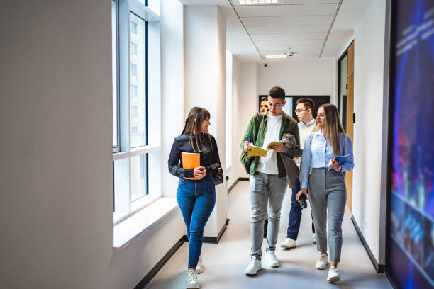 istock Small group of university students chatting after class while walking in the hallway 1774730655