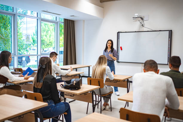 istock Students sitting in a classroom listening to their  teacher 1774730663
