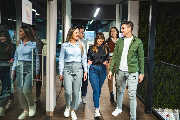 istock Small group of university students chatting before class while walking in the hallway 1774744233