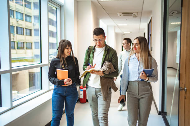 istock Group of university students talking while walking through the hallway on their way to class 1774753414