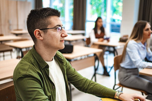 istock Male student sitting in a classroom listening to class 1774754714