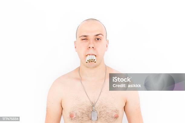 Man With A Mouth Full Of Many Cigarettes Stock Photo - Download Image Now - 30-39 Years, Addiction, Adult