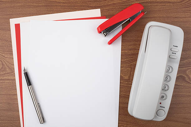 Sheets of paper and office accessories on wooden texture stock photo