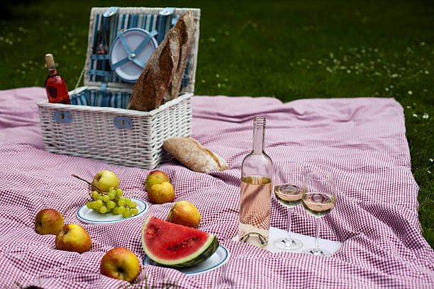 istock Wine and picnic basket on the grass 177477880
