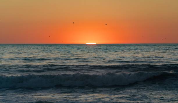 istock the sun is setting over the ocean at the beach shore 1774801133