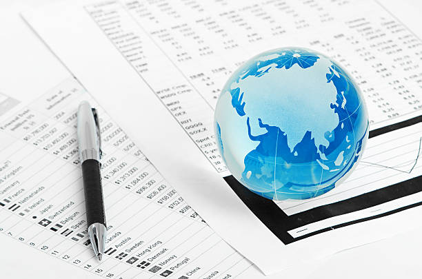 istock Glass globe and pen on finance 177480401