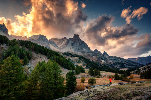 istock Sunset over Claree Valley with Main De Crepin peak and river flow through in larch forest during autumn at French Alps, France 1774835552