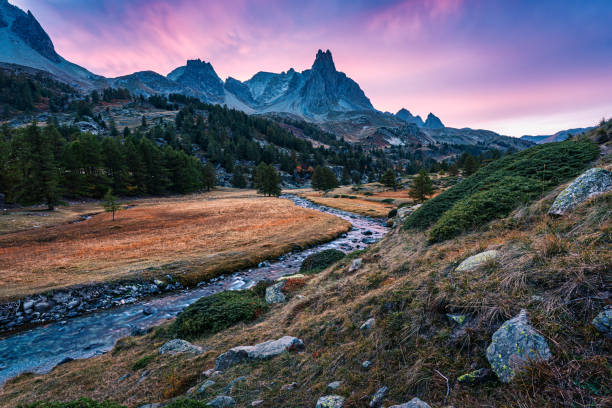 istock Sunset over Claree Valley with Main De Crepin peak and river flow through in larch forest during autumn at French Alps, France 1774835561