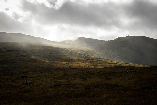 An autumn afternoon in Glencoe, Scottish highlands, with stormy clouds and dramatic light