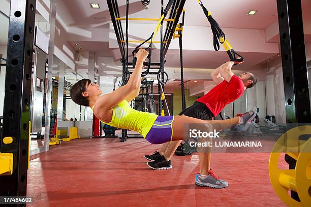 Man And Woman Training Trx Fitness Exercises At The Gym Stock Photo - Download Image Now