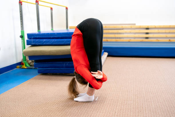 istock female athlete doing stretching before acrobatics training in the gym 1774856287