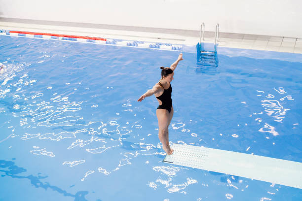 istock female athlete stands on a springboard, diving competition 1774856830