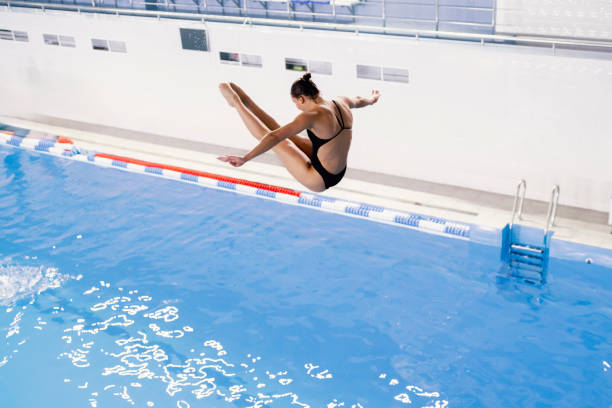 istock sports diving, an athlete doing a somersault, jumping from a springboard into the pool 1774856846