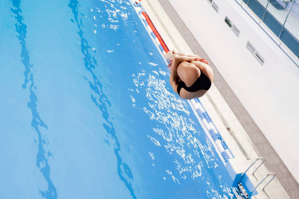 istock sports diving, an athlete doing a somersault, jumping from a springboard into the pool 1774856850