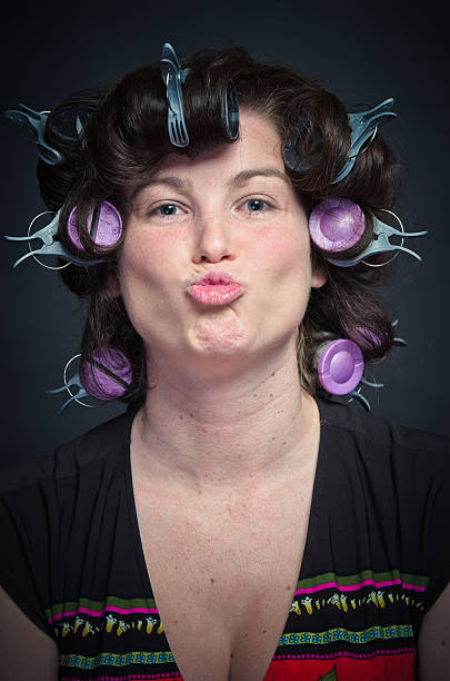 istock Woman with Curlers making a face 177487811