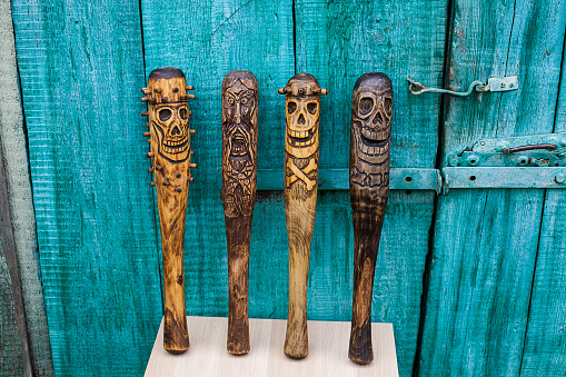 handmade wooden baseball bat, wood carving, skull image, skeleton drawing.