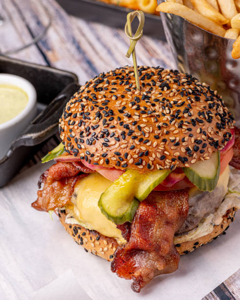 istock A delicious burger featuring a juicy beef patty, crispy bacon, caramelized onions, ripe tomato, and perfectly cooked fries would be a mouthwatering delight 1774888954