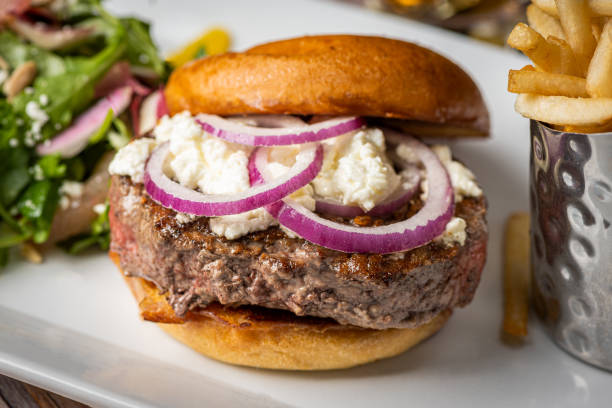 istock A delicious burger featuring a juicy beef patty, crispy bacon, caramelized onions, ripe tomato, and perfectly cooked fries would be a mouthwatering delight 1774889017