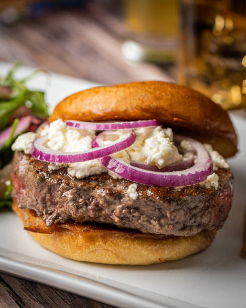 istock A delicious burger featuring a juicy beef patty, crispy bacon, caramelized onions, ripe tomato, and perfectly cooked fries would be a mouthwatering delight 1774889021