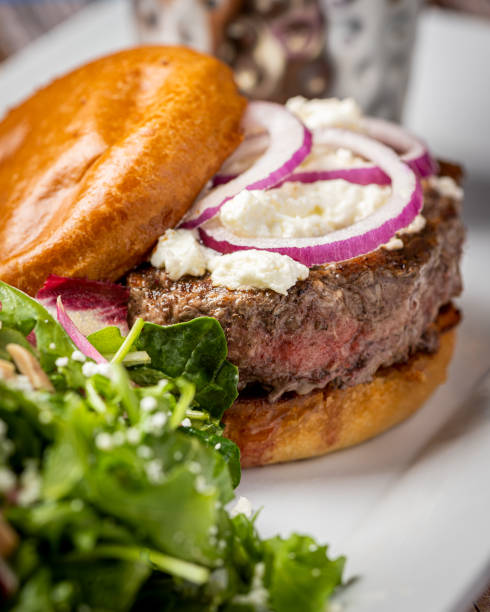 istock A delicious burger featuring a juicy beef patty, crispy bacon, caramelized onions, ripe tomato, and perfectly cooked fries would be a mouthwatering delight 1774889029