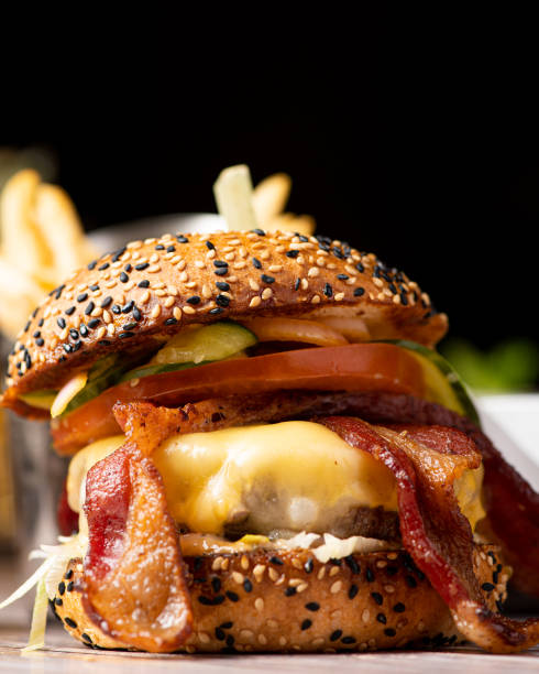 istock A delicious burger featuring a juicy beef patty, crispy bacon, caramelized onions, ripe tomato, and perfectly cooked fries would be a mouthwatering delight 1774889047