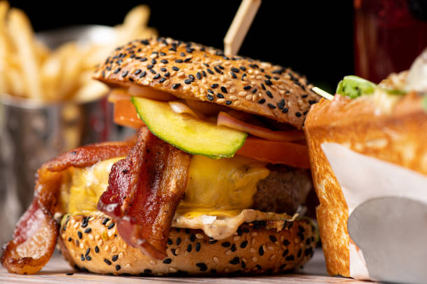 istock A delicious burger featuring a juicy beef patty, crispy bacon, caramelized onions, ripe tomato, and perfectly cooked fries would be a mouthwatering delight 1774889049