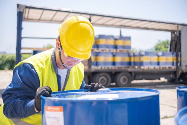 istock A warehouse worker manually adjusts drums of motor oil. 1774897601