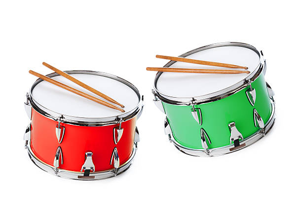 Two Drums with Sticks Isolated on White Background Subject: A red drum with drum sticks isolated on a white background. snare drum photos stock pictures, royalty-free photos & images