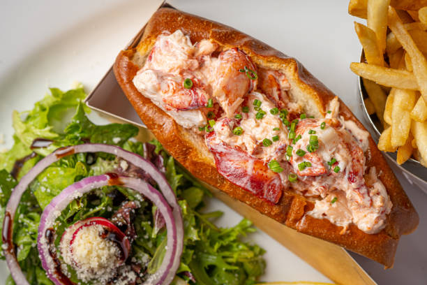 istock A lobster roll is a delectable seafood delicacy that exudes coastal charm and culinary excellence. It typically consists of succulent lobster meat, gently cooked and generously mixed with a light mayonnaise-based dressing. This flavorful lobster mixture i 1774904689