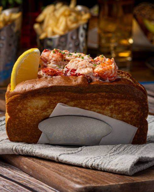 istock A lobster roll is a delectable seafood delicacy that exudes coastal charm and culinary excellence. It typically consists of succulent lobster meat, gently cooked and generously mixed with a light mayonnaise-based dressing. This flavorful lobster mixture i 1774905301