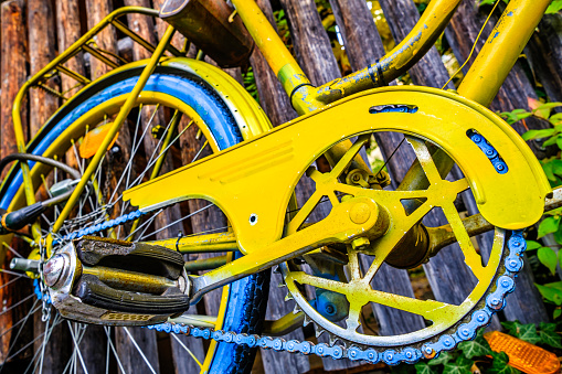 Fragment of a bicycle wheel. With a yellow rim. Disc brake visible.