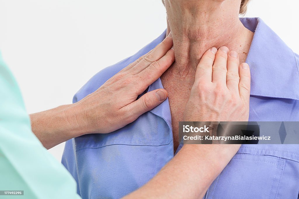 Thyroid problems Problems with thyroid, nurse examining a patient Thyroid Gland Stock Photo