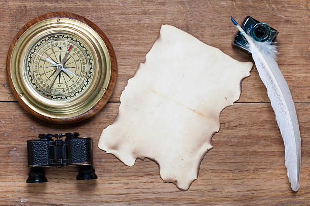 istock Compass, old paper, binoculars, quill and inkwell on wood 177492800