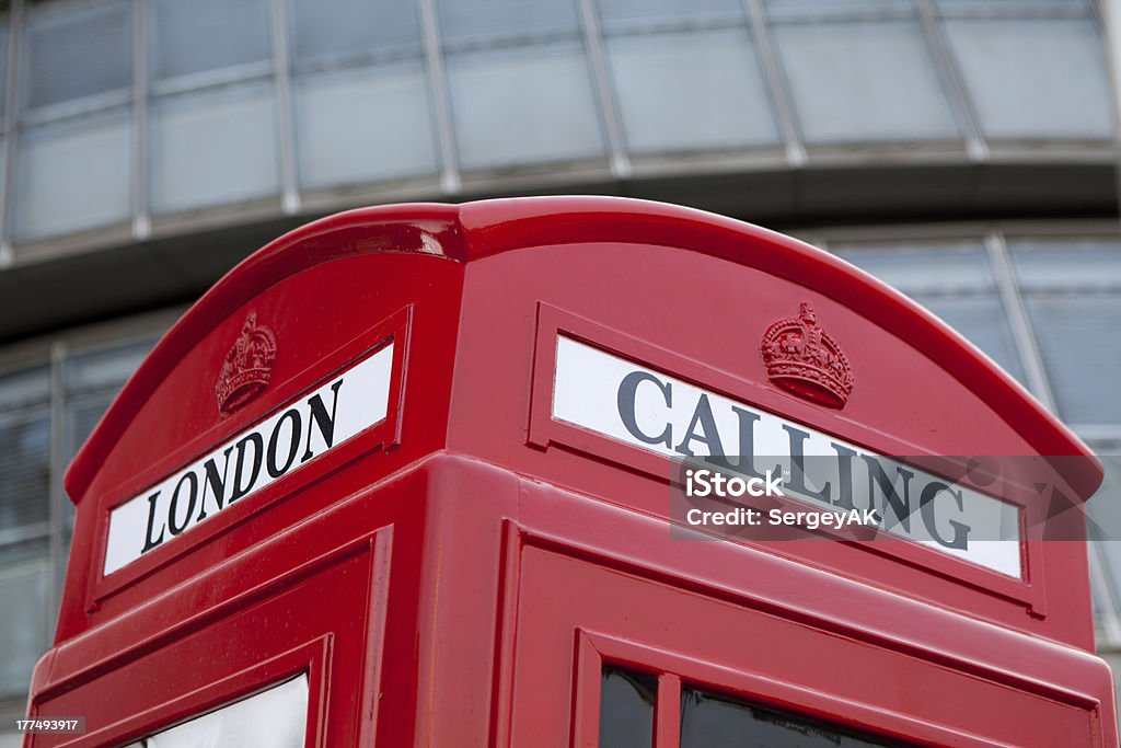 London calling symbol red phone box on business center background Traditional London symbol red public phone box for calling on the modern business center faAade background Box - Container Stock Photo