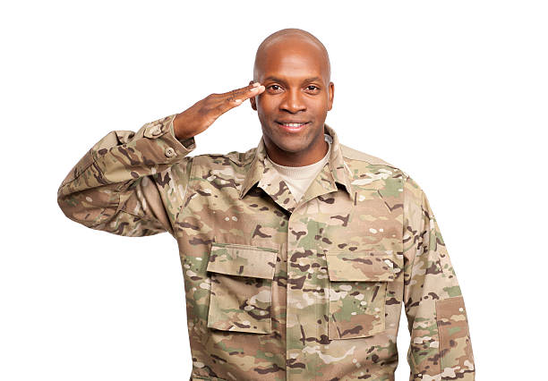 Happy serviceman salutes stock photo