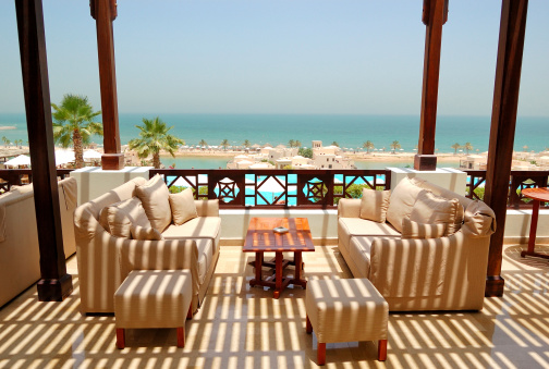 Abu Dhabi, United Arab Emirates – November 12, 2022: The vast infinity pool with palm trees and cabanas at the Al Wathba Desert Resort and Spa