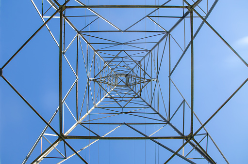 Electric pylon in residential area during autumn day in Quebec city seen from below