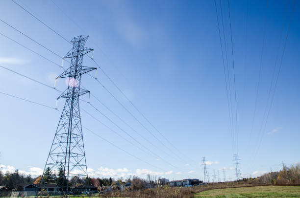 Electric pylon in residential area during autumn day in Quebec city seen from below