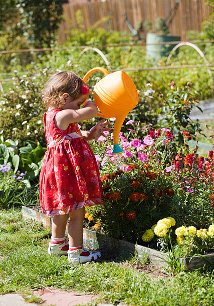 istock girl watering flower beds 177496222