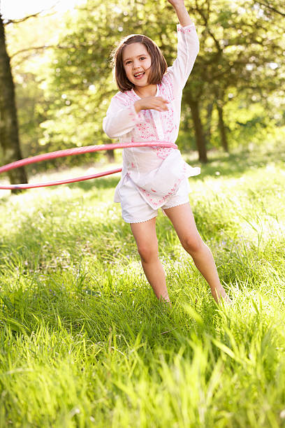 istock Young Girl Playing With Hula Hoop In Summer Field 177497011