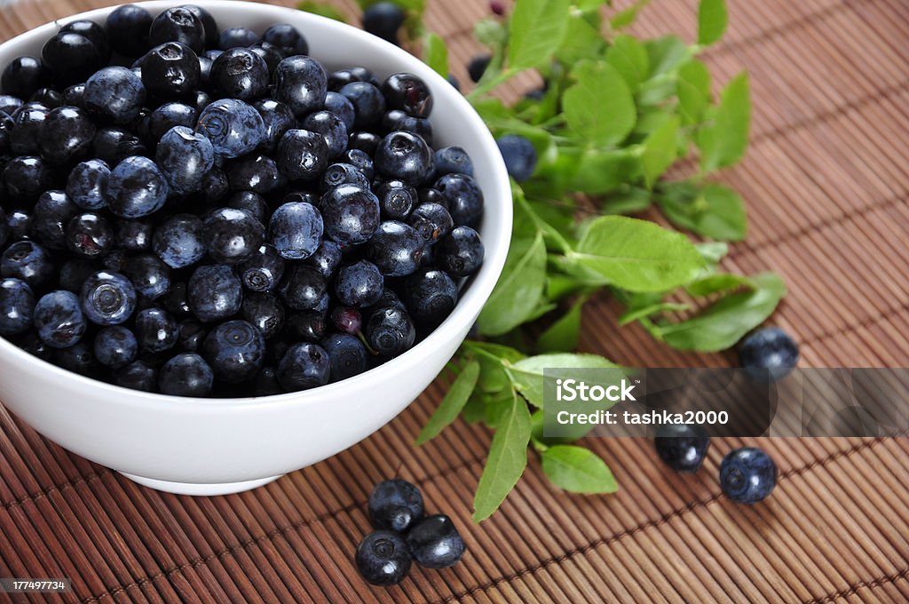 Blueberries Blueberries in a white bowl with  and blueberry twigs Berry Fruit Stock Photo