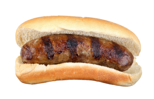 Grilled bratwurst on a bun isolated on white