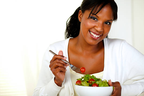 istock Lovely young female enjoying fresh vegetable salad 177497975