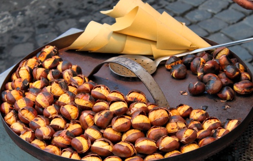 Grilled chestnuts for sale in a market stall
