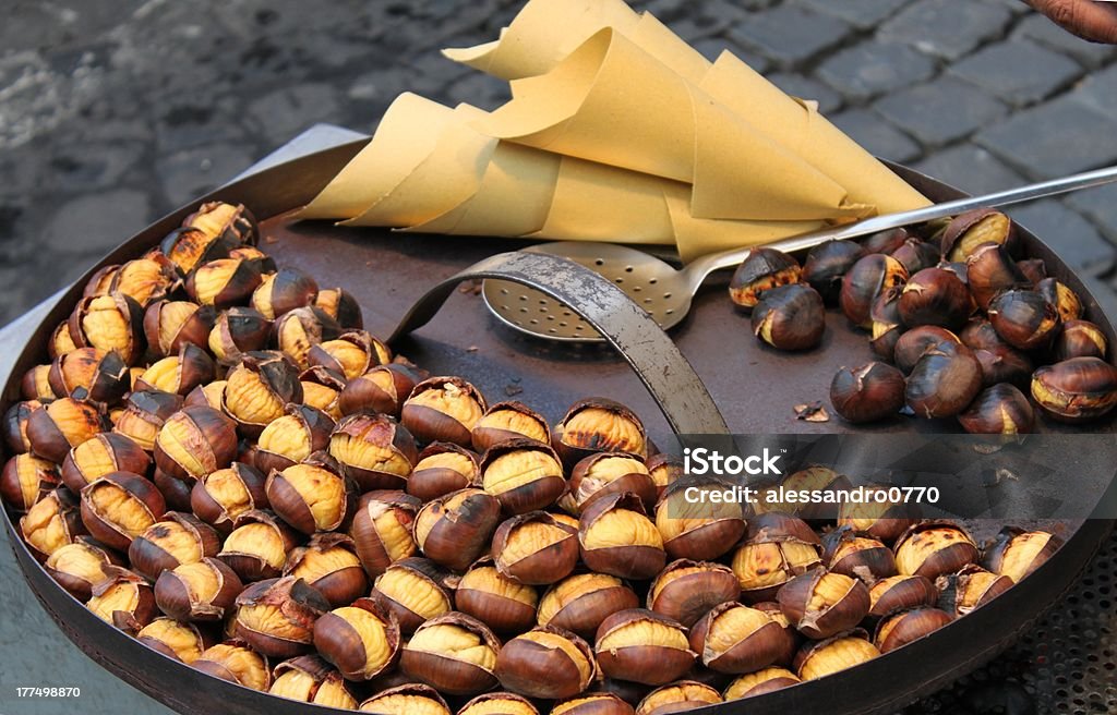 Grilled chestnuts Grilled chestnuts for sale in a market stall Chestnut - Food Stock Photo