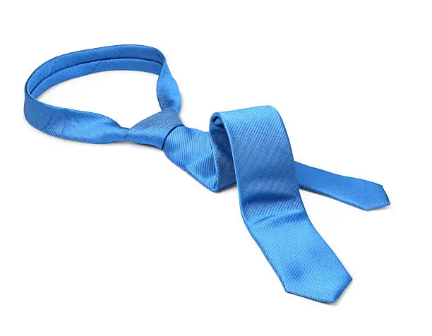 Blue men's tie taken off for leisure time, white background isolated