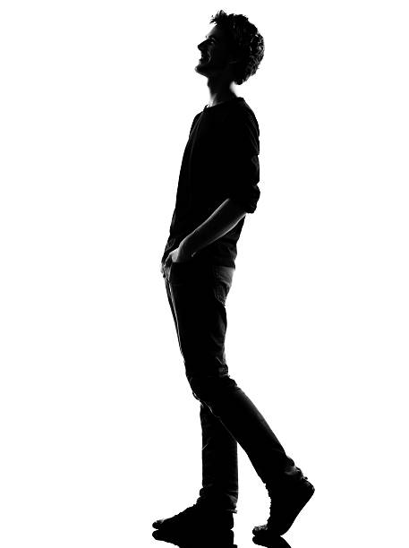 istock young man silhouette walking  happy laughing 177499088