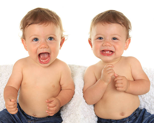 Twin baby boys. Twin baby boys. Ten months old. animal saliva stock pictures, royalty-free photos & images